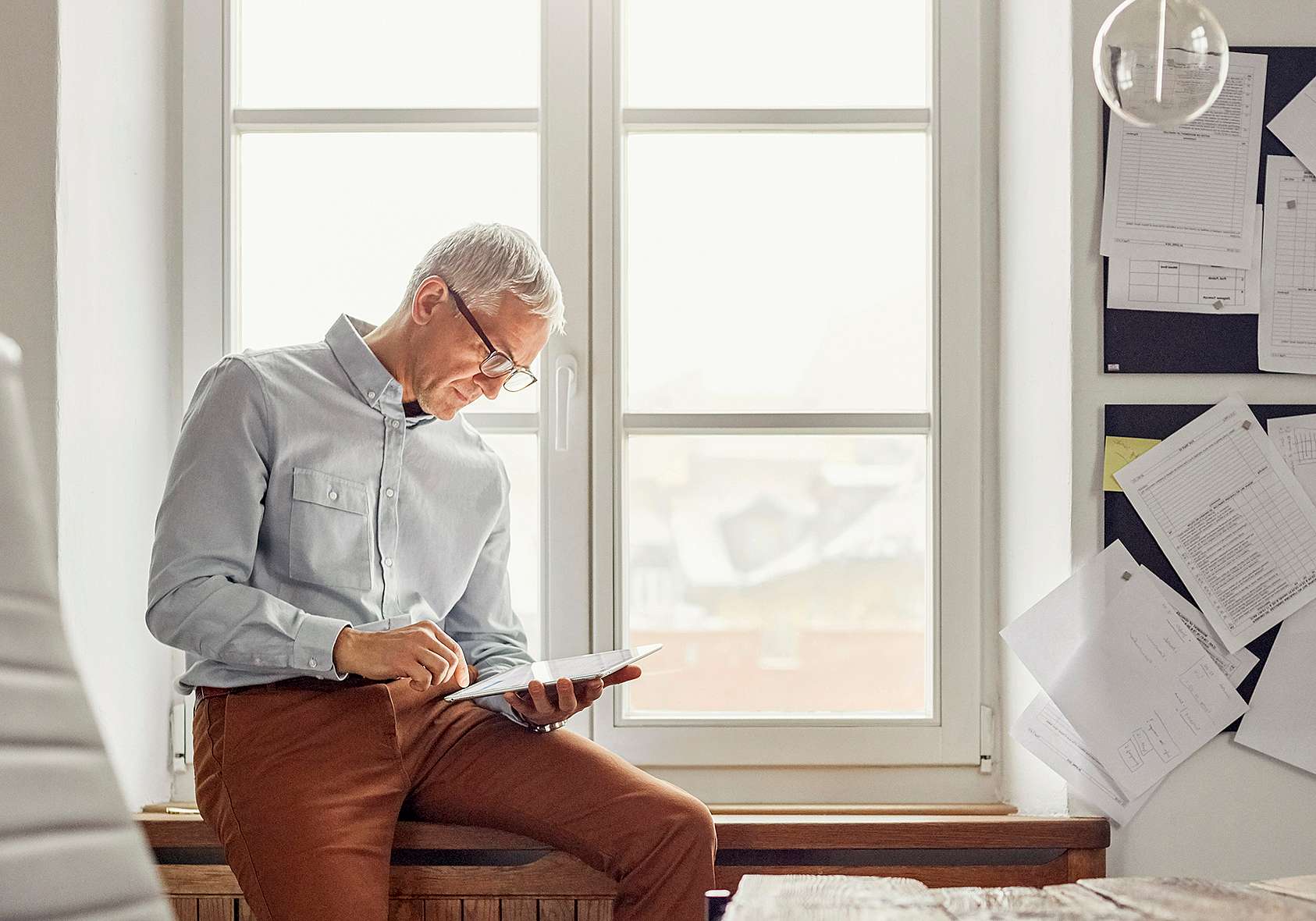 Senior businessman reviewing lease contract documents, exploring options for lease termination, equipment return, and expert advice from grenke customer care.