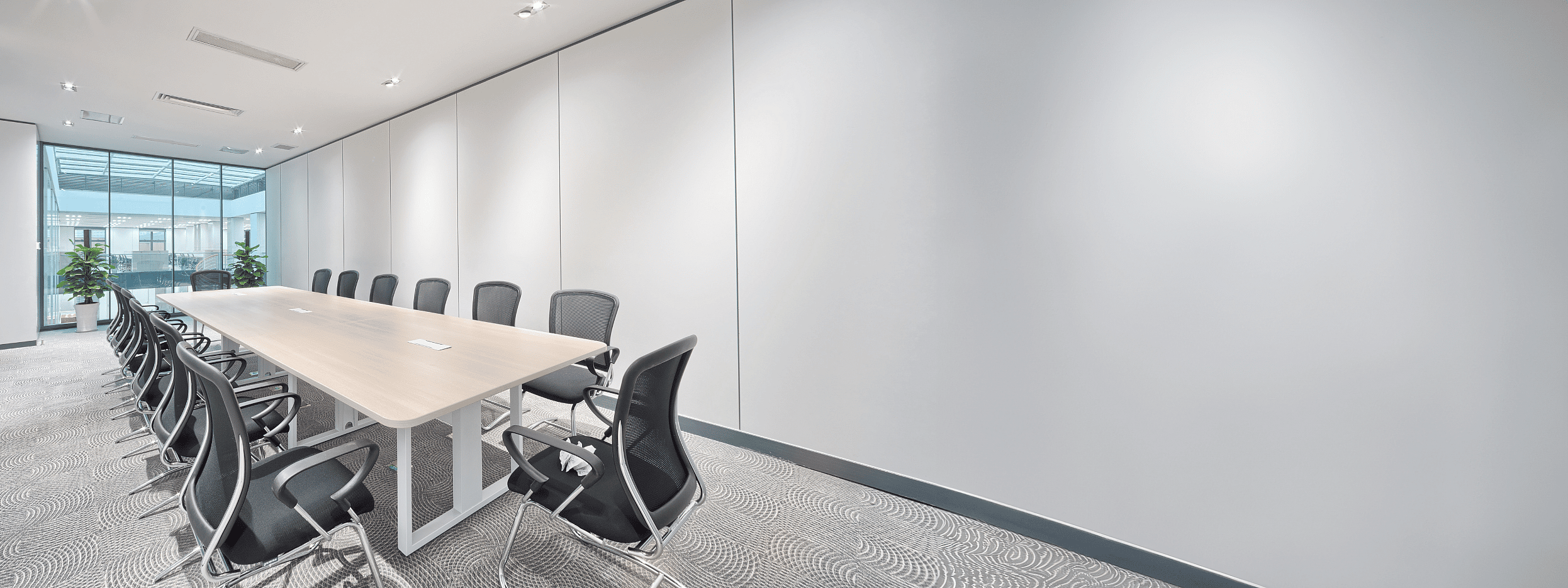 Stylish meeting room with modern desks, chairs, and storage solutions, showcasing flexible office furniture leasing options for a productive work environment.
