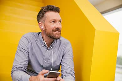 Offering the best sales expertise, a man on the phone smiling