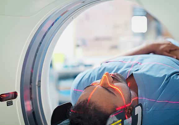 Close-up of a patient being scanned in a CT scan machine, highlighting grenke's financing options for medical equipment, including diagnostic machines and patient care equipment, to ensure high standards of healthcare.