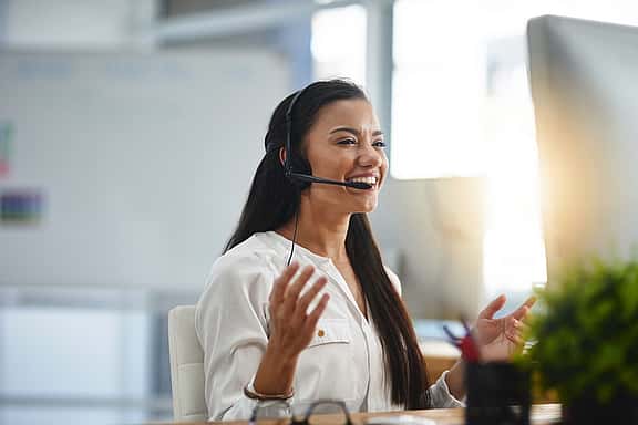 Woman using a headset to support a customer with a query.