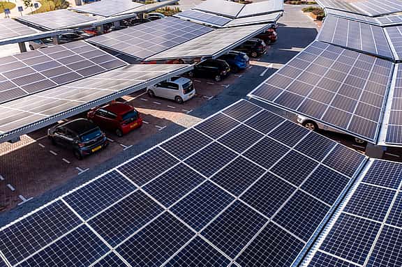 Solar panels on a car park roof, illustrating grenke's financing solutions for green technology including solar panels, energy-efficient lighting, and eco-friendly technologies to reduce carbon footprint and operational costs.