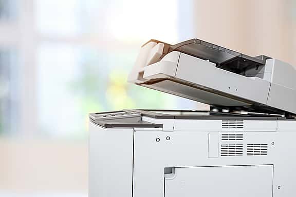 Close-up of an office copier, illustrating grenke's leasing solutions for various types of photocopiers, including mono, colour, A3, and multifunction models.