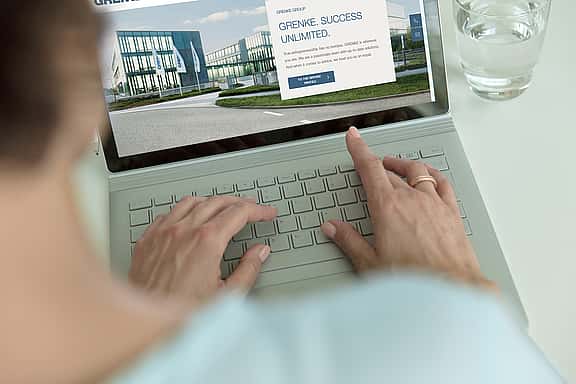 Person using laptop to update email preferences for receiving invoices on grenke Customer Care page