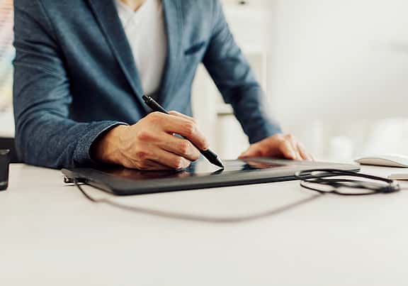 Close-up of hands writing on an iPad, addressing equipment issues and responsibilities for maintaining equipment during the lease period.