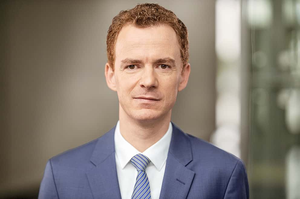 Photo of Dr. Sebastian Hirsch, CEO of grenke, representing ambitious growth targets and leadership transition.