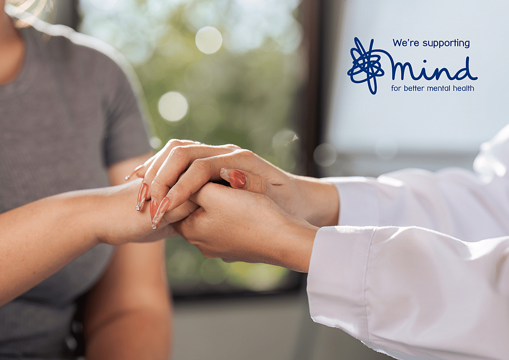 Close-up of a supportive hand gesture symbolising mental health awareness, alongside the Mind charity logo.