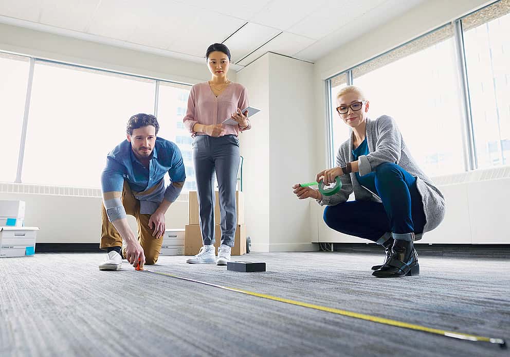 Team in a modern office, embodying innovation and adaptation, showcasing grenke UK's dynamic approach through LCCI membership.